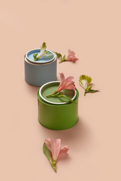 Two tins of green and blue paints with spring flowers