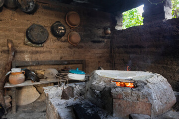 Traditional kitchen inside a house with mud walls 