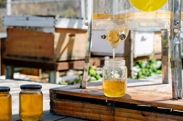 Equipments and bottle of honey on beehive