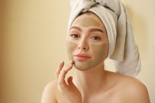 Young Woman Applying Facemask