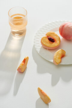 Peach cocktail and peach fresh on a white table background