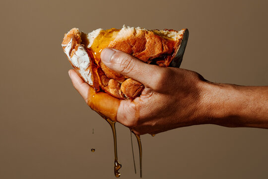 has a piece of bread soaked in olive oil
