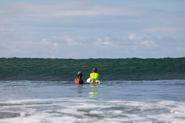 Nervous Young Boy Learning to Surf in Costa Rica with surf instructor
