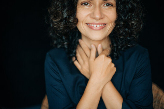 Woman looking at camera with hope and smile