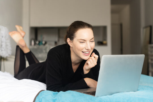 Woman laughing at computer