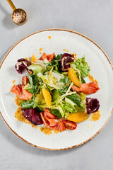 Healthy food - salmon salad with vegetables, greens and citrus. Summer salad with salmon, beetroot,...