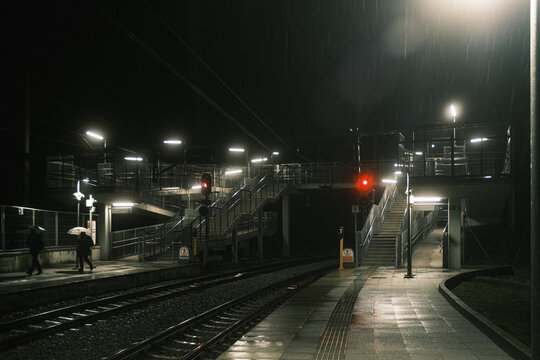 Outdoors train station a rainy night