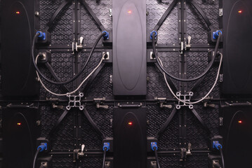 The back side of a large LED screen monitor. The texture of the rear view of the led panels. Power...