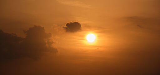 Bright colorful sunset sky with rays of setting sun and vivid dark clouds