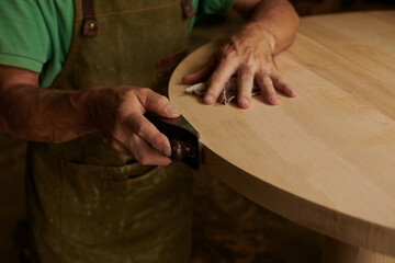 Carpenter using a Planer