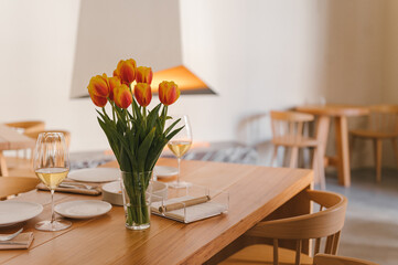 Served table with bouquet of flowers and tableware
