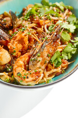 Japanese soba with seafood cooked on wok in asian style on white background. Noodle seafood in ceramic bowl. Indonesian wok with prawn, mussels and soba noodles. Spicy thai dish with shrimp and udon.