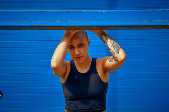 Portrait of a non binary model over a blue background