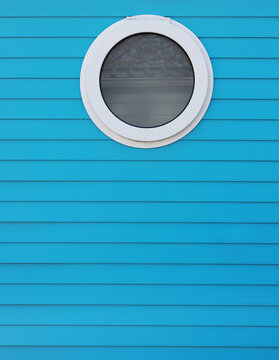 round window in blue wall