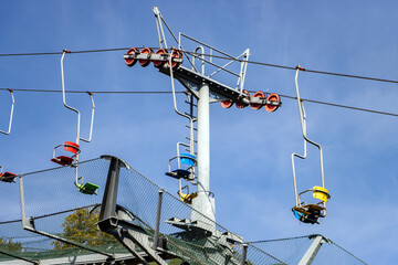 A chairlift pillar with moving empty seats