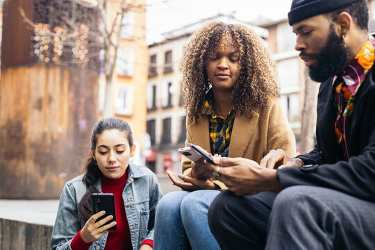 Friends Meeting In The City Using Cell Phones