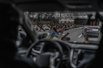 View from car on steel anti tank obstacles on road