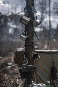Trench life with cups on tree and tents on background