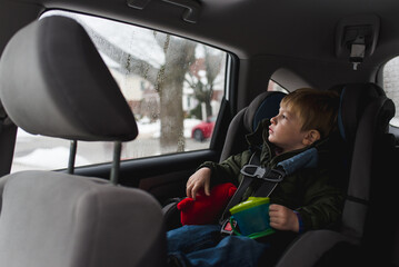 Little boy sitting in car