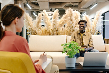 Black man having business advice in modern office