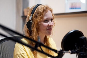 Young lady recording radio podcast