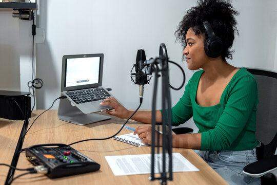 Stylish black woman working in radio studio