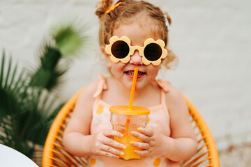 young girl having a drink outdoors