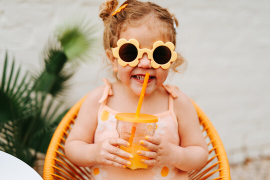 young girl having a drink outdoors