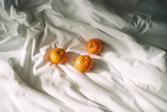 Oranges on bed