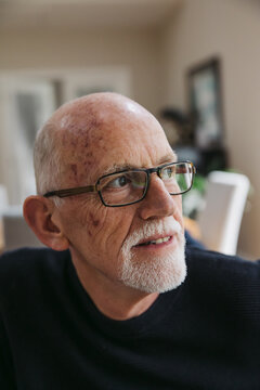 Mature man sitting at home.