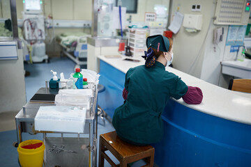 Female Asian Nurse Working At A Hospital Desk In Anhui, China.