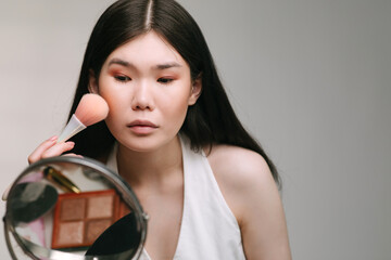 Woman applying make up