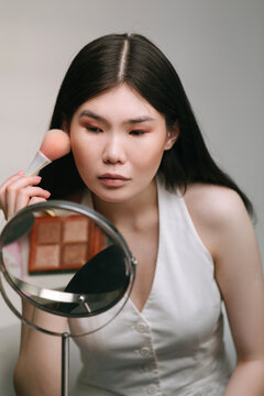 Woman applying make up