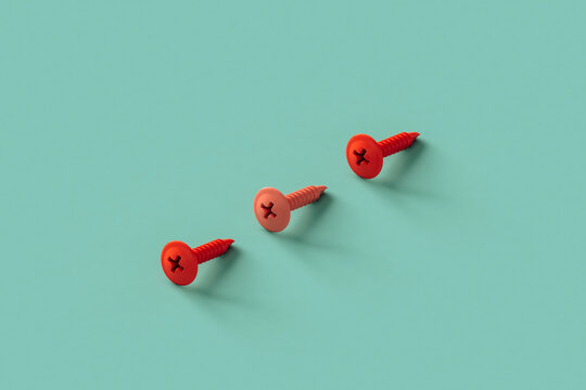 three pink screws on blue background