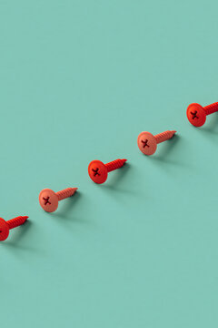 a row of pink screws on a blue background with copy space