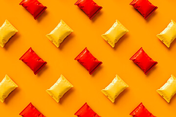 top-down view of orange and red chips packages with no label.