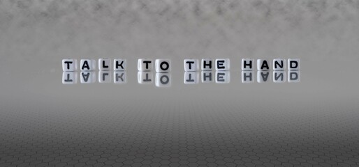 talk to the hand word or concept represented by black and white letter cubes on a grey horizon...