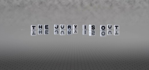the jury is out word or concept represented by black and white letter cubes on a grey horizon...