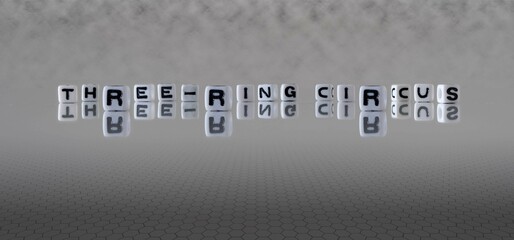 three ring circus word or concept represented by black and white letter cubes on a grey horizon background stretching to infinity