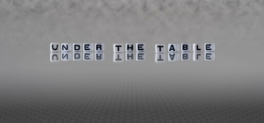 under the table word or concept represented by black and white letter cubes on a grey horizon...