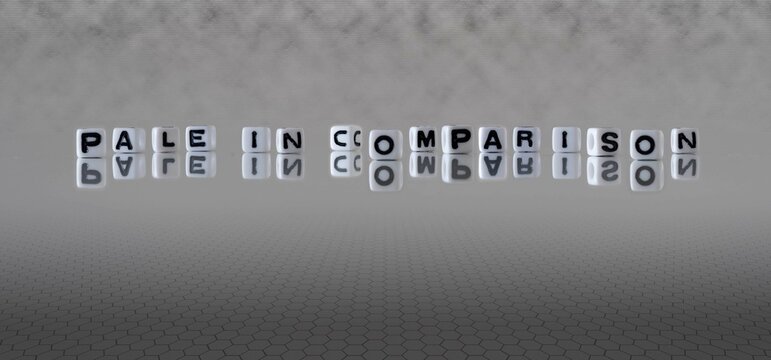 pale in comparison word or concept represented by black and white letter cubes on a grey horizon background stretching to infinity