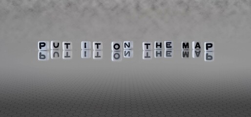 put it on the map word or concept represented by black and white letter cubes on a grey horizon background stretching to infinity