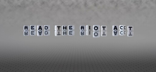 read the riot act word or concept represented by black and white letter cubes on a grey horizon...