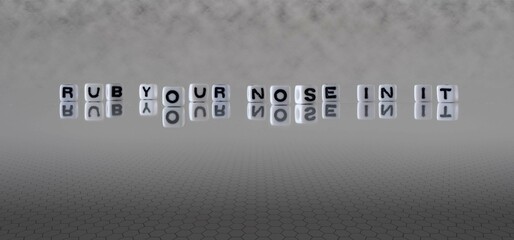 rub your nose in it word or concept represented by black and white letter cubes on a grey horizon...