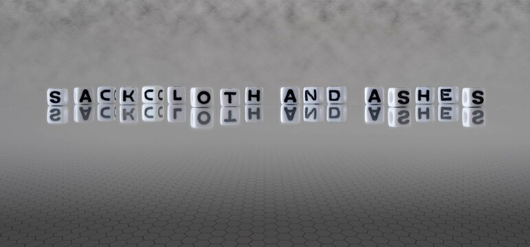 sackcloth and ashes word or concept represented by black and white letter cubes on a grey horizon background stretching to infinity
