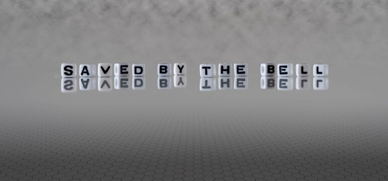 saved by the bell word or concept represented by black and white letter cubes on a grey horizon background stretching to infinity
