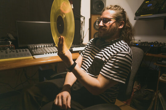 A man with a vinyl record in his hand