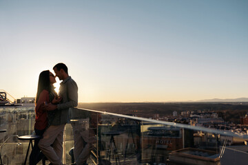 Loving couple kissing on rooftop
