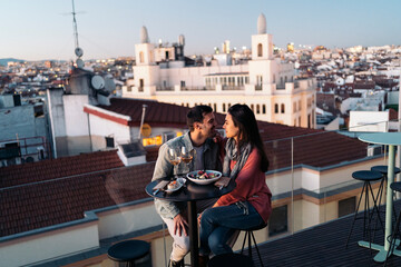 Loving couple enjoying romantic date on rooftop