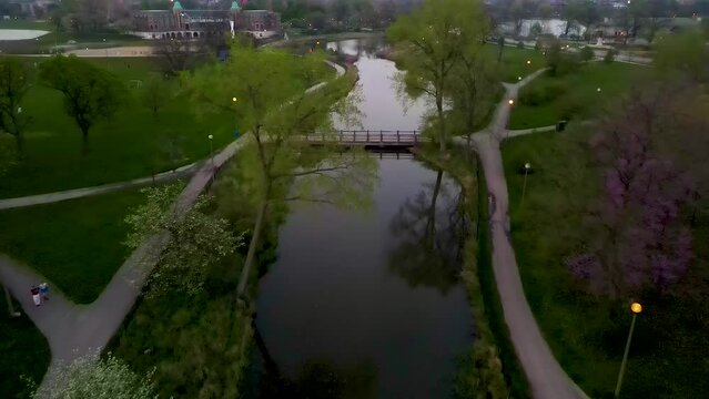 aerial drone view of a local park in Chicago westside during a beautiful evening. the natural green environment and clear water is great for tourism sightseeing